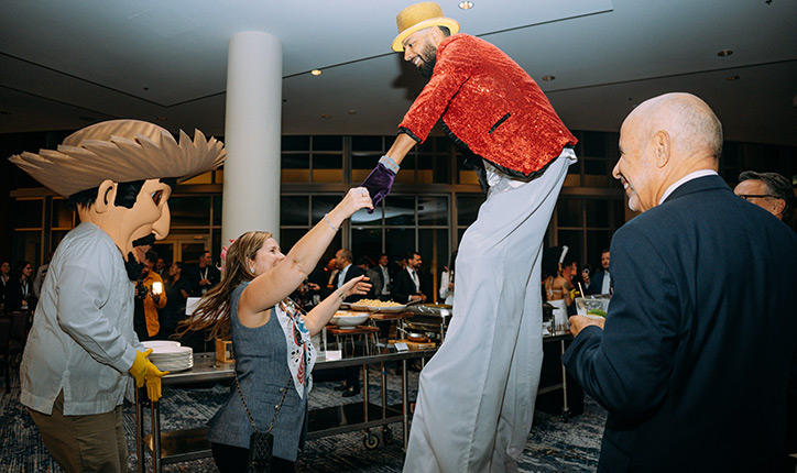 Stilt walker entertainer greeting attendees at the 2025 Forum